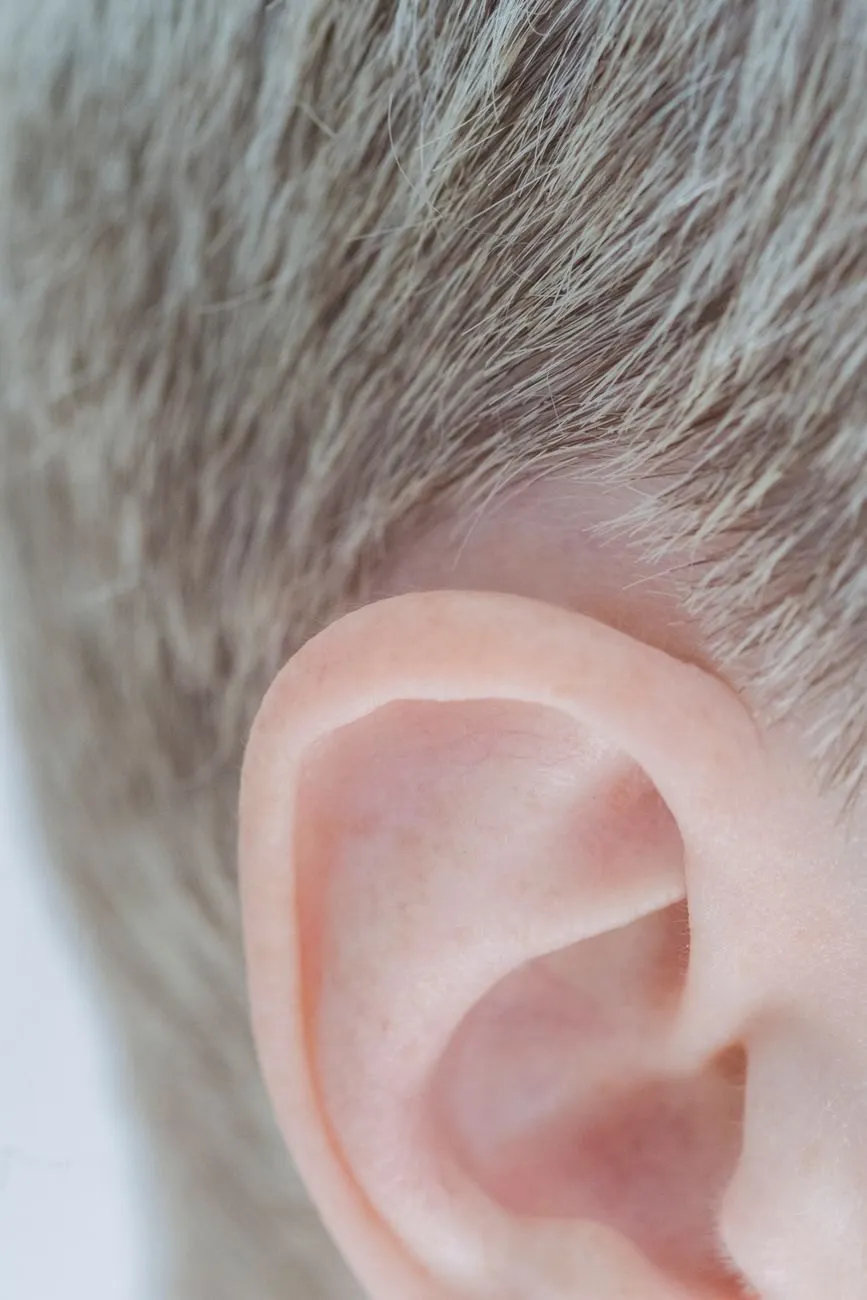 Close view of an older man's ear framed by short grey hair